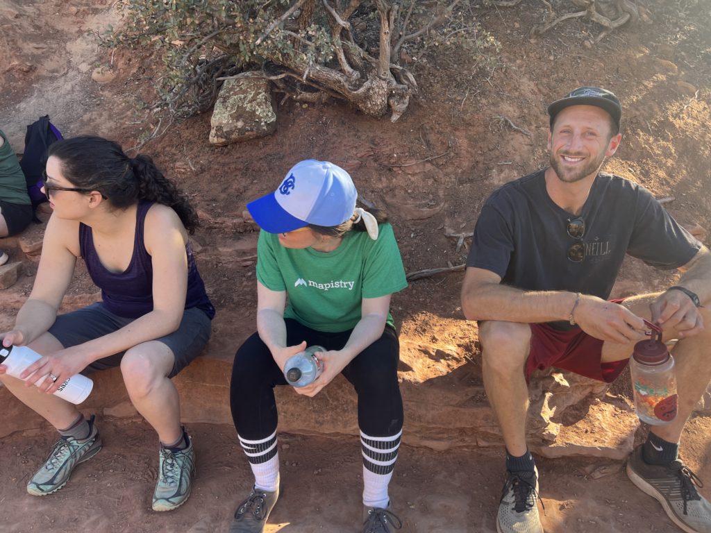 Three people taking a break while hiking