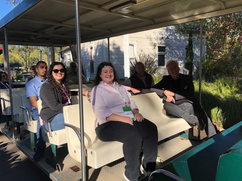 People riding a tram at a winery