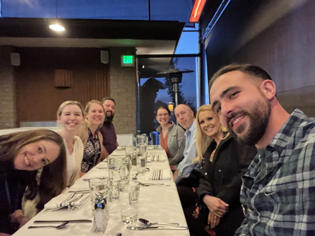 Eight people at a long dinner table