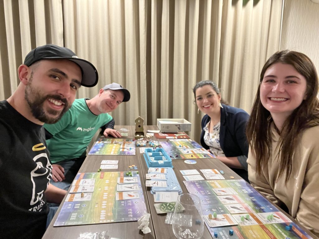 Four people playing Wingspan